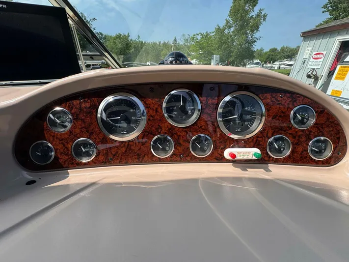  Yacht Photos Pics Dashboard of 2002 Sea Ray 360 Sundancer with multiple gauges and wood paneling.