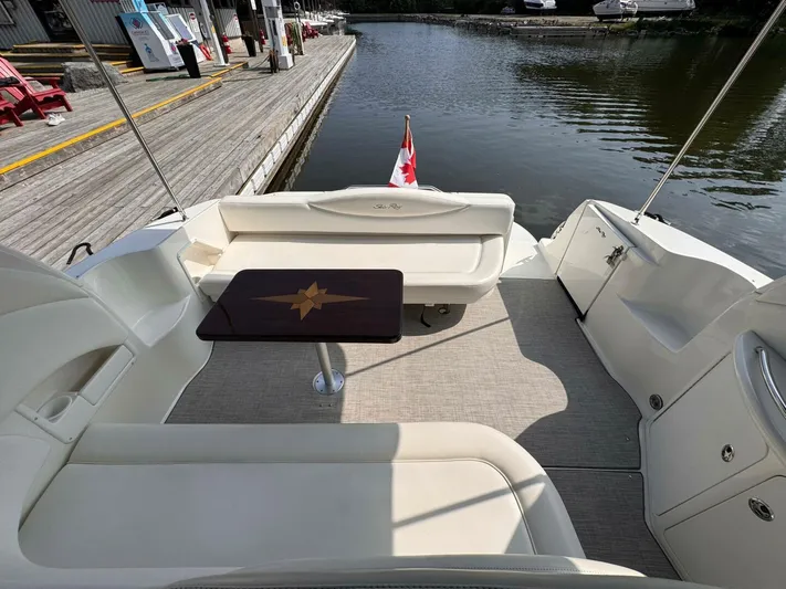  Yacht Photos Pics 2002 Sea Ray 360 Sundancer boat interior with seating and table, docked by the water.