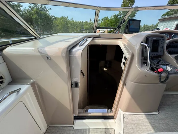  Yacht Photos Pics 2002 Sea Ray 360 Sundancer cockpit with open cabin door, showcasing navigation equipment.