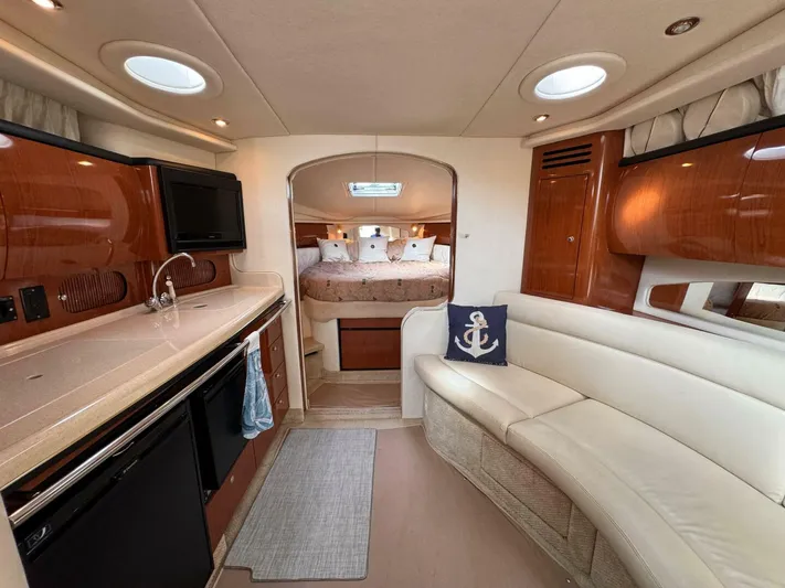 Yacht Photos Pics Interior of 2002 Sea Ray 360 Sundancer yacht with kitchen and cozy seating area.