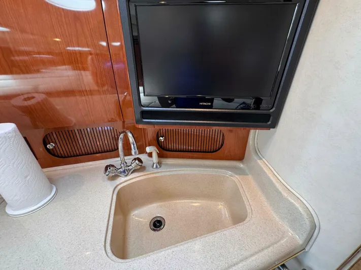  Yacht Photos Pics 2002 Sea Ray 360 Sundancer interior with sink and TV in kitchen area.