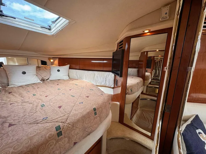  Yacht Photos Pics Luxurious interior of 2002 Sea Ray 360 Sundancer yacht with cozy bed and elegant wood finishes.