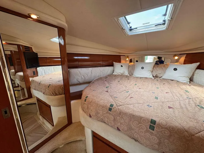  Yacht Photos Pics Luxurious interior of 2002 Sea Ray 360 Sundancer yacht with spacious bed and elegant decor.