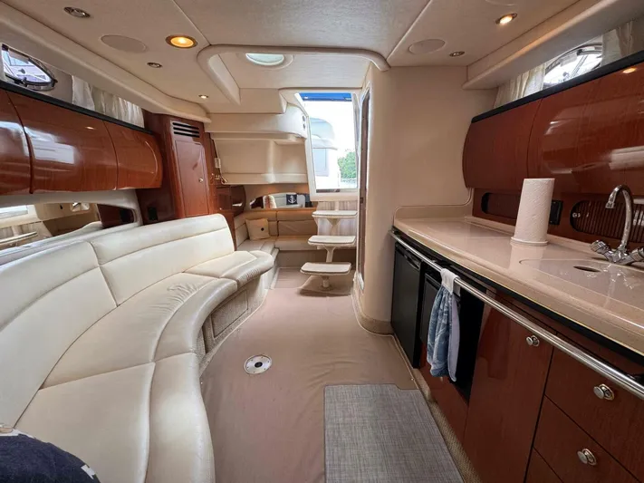  Yacht Photos Pics Luxurious interior of a 2002 Sea Ray 360 Sundancer yacht with elegant seating and kitchenette.