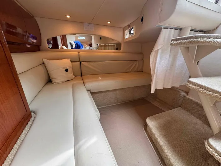  Yacht Photos Pics Interior of 2002 Sea Ray 360 Sundancer yacht with beige seating and carpeted stairs.