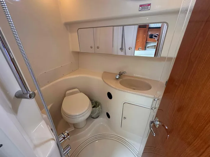  Yacht Photos Pics 2002 Sea Ray 360 Sundancer bathroom with toilet, sink, and mirrored cabinet.