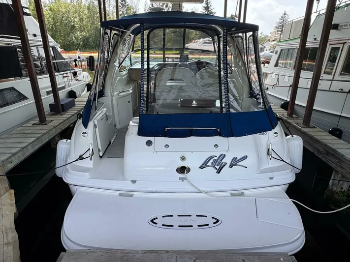  Yacht Photos Pics 2002 Sea Ray 360 Sundancer docked, rear view with blue canopy and "Lily K" name.