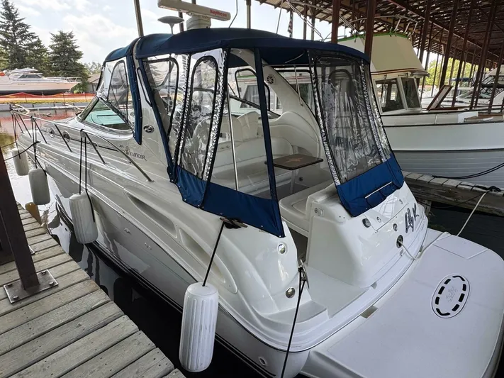  Yacht Photos Pics 2002 Sea Ray 360 Sundancer docked, featuring blue canopy and sleek white design.