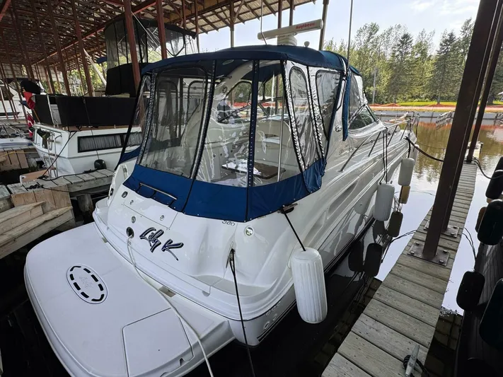  Yacht Photos Pics 2002 Sea Ray 360 Sundancer docked, featuring blue canopy and white hull.