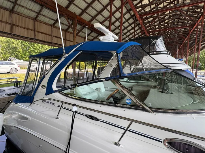  Yacht Photos Pics 2002 Sea Ray 360 Sundancer yacht with blue canopy in a covered marina.