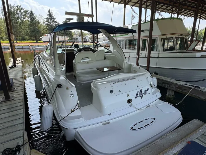 Yacht Photos Pics 2002 Sea Ray 360 Sundancer docked in a marina, featuring a spacious deck and seating area.