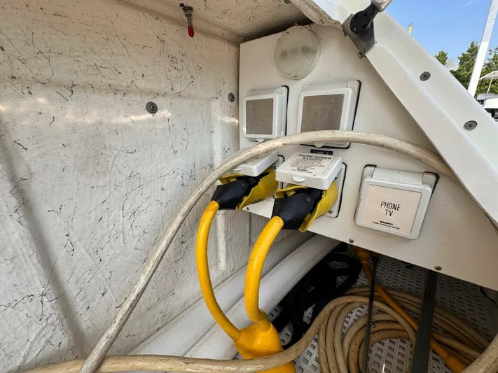  Yacht Photos Pics Electrical connections on a 2002 Sea Ray 360 Sundancer boat, featuring power and phone/TV outlets.