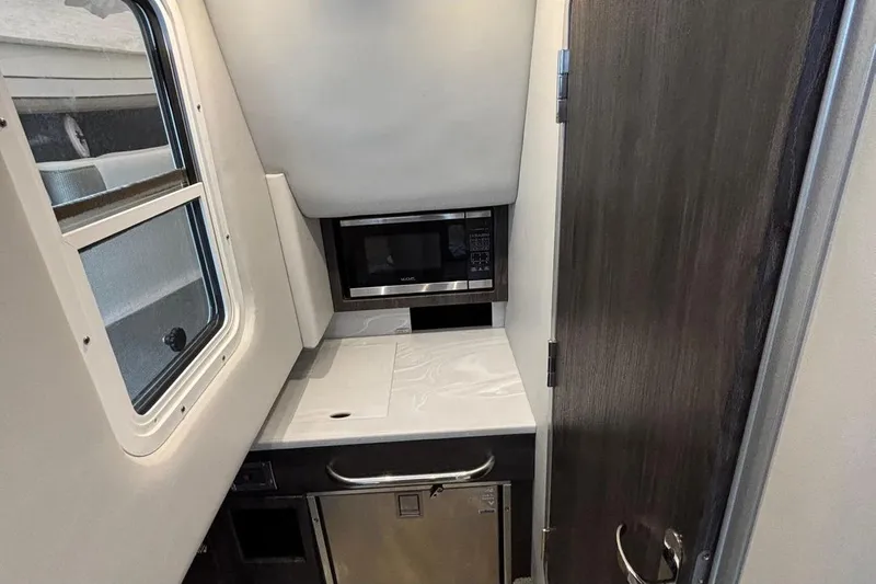  Yacht Photos Pics Interior of 2022 Formula 350 Crossover Bowrider OB with microwave and compact kitchen area.