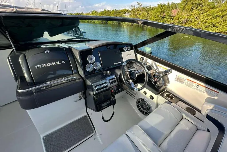  Yacht Photos Pics 2022 Formula 350 Crossover Bowrider OB cockpit with modern controls and luxurious seating.