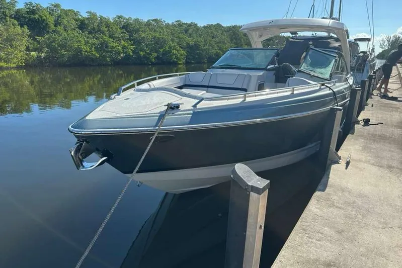  Yacht Photos Pics 2022 Formula 350 Crossover Bowrider OB docked by a serene waterway.