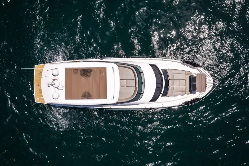 La Peque Yacht Photos Pics Aerial view of 2016 Prestige 620 yacht cruising on open water.