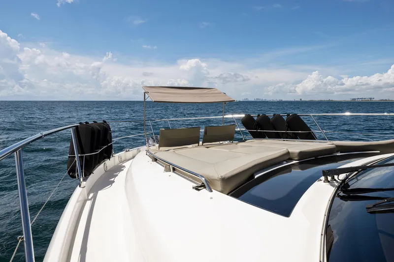 La Peque Yacht Photos Pics Prestige 620 yacht 2016 model cruising on open sea under clear blue sky.