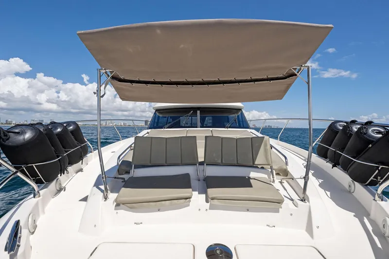 La Peque Yacht Photos Pics Prestige 620 yacht 2016 model with sunshade and lounge seating on deck.