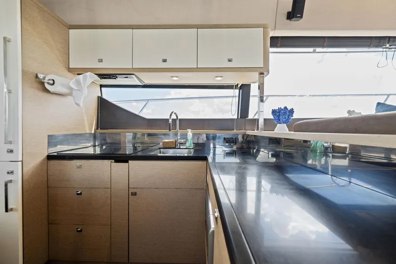 La Peque Yacht Photos Pics Modern kitchen interior of 2016 Prestige 620 yacht with sleek countertops and ample storage.