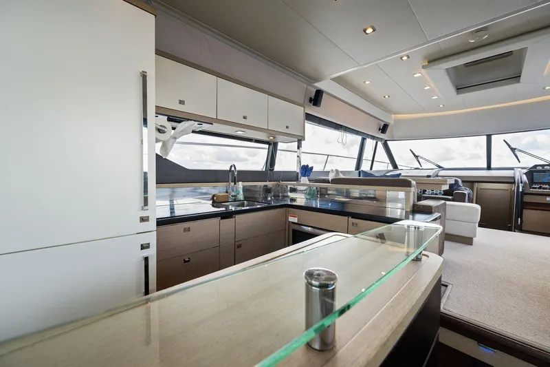 La Peque Yacht Photos Pics Modern kitchen interior on a 2016 Prestige 620 yacht with panoramic windows.