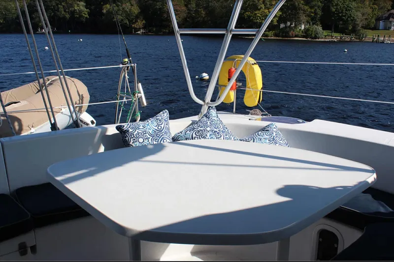 Destiny 2 Yacht Photos Pics Fountaine Pajot Belize 43 catamaran deck with cushions, moored on a serene lake.