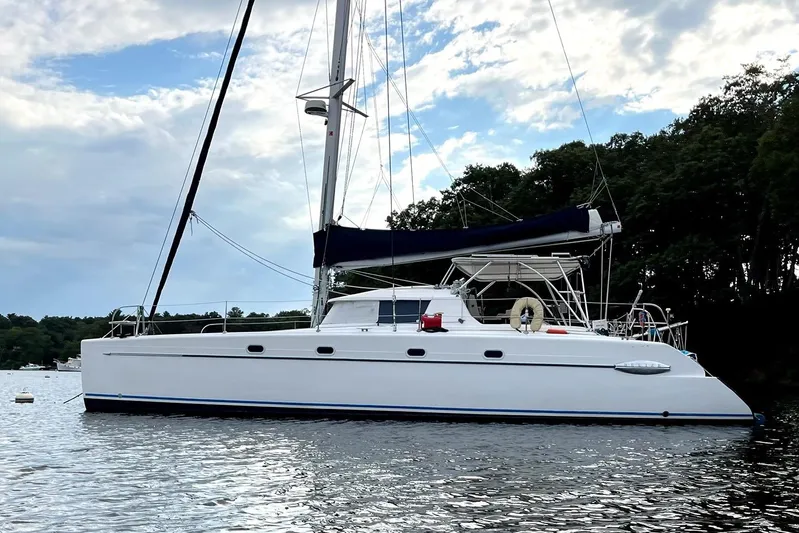 Destiny 2 Yacht Photos Pics Sailing catamaran Fountaine Pajot Belize 43, 2000 model, anchored on calm water.