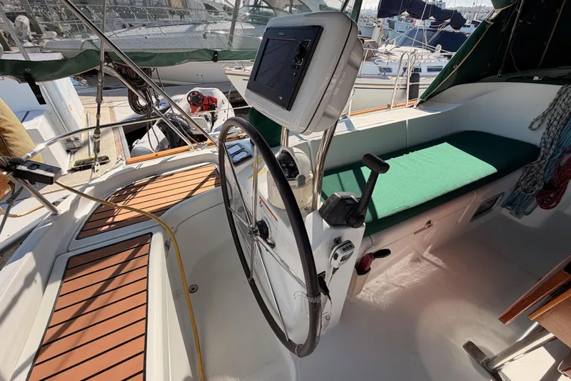 Parlay Yacht Photos Pics Cockpit of 2003 Beneteau Oceanis Clipper 473 sailboat with steering wheel and navigation equipment.