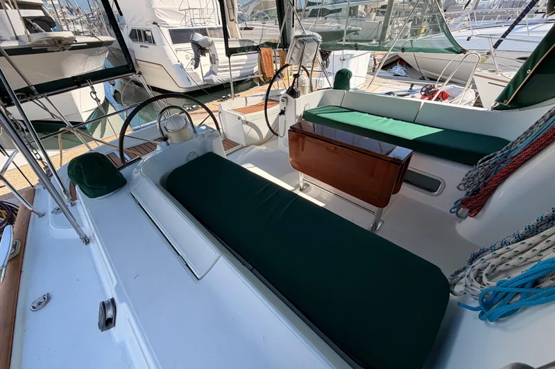 Parlay Yacht Photos Pics 2003 Beneteau Oceanis Clipper 473 cockpit with green cushions and steering wheel.