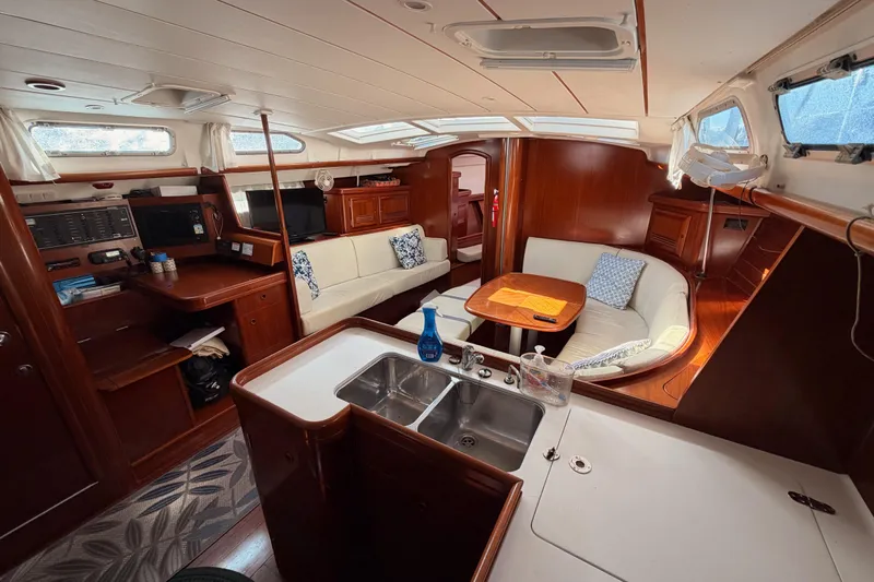 Parlay Yacht Photos Pics Interior of 2003 Beneteau Oceanis Clipper 473 yacht with elegant wood finish and seating area.