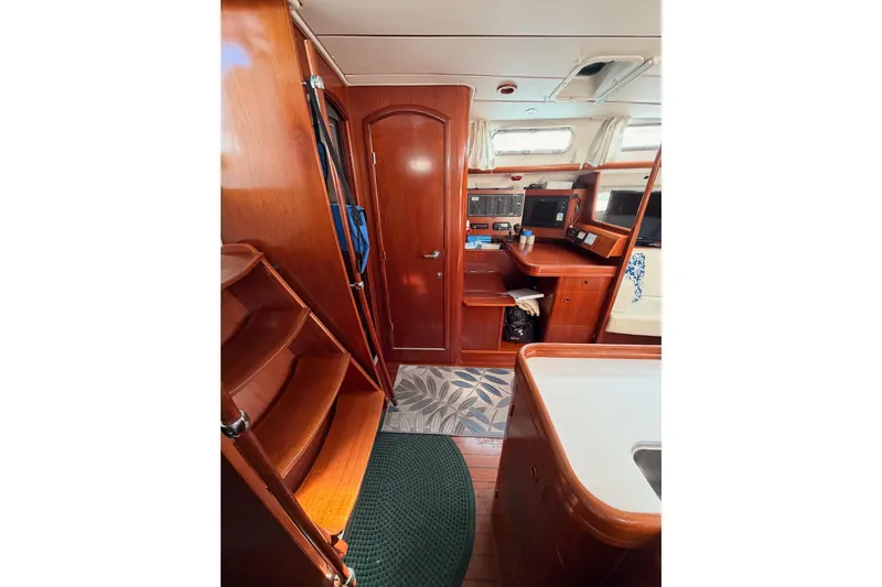 Parlay Yacht Photos Pics Interior of 2003 Beneteau Oceanis Clipper 473 yacht with wooden cabinetry and navigation station.