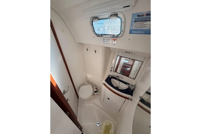 Parlay Yacht Photos Pics Bathroom interior of 2003 Beneteau Oceanis Clipper 473 yacht, featuring compact design.