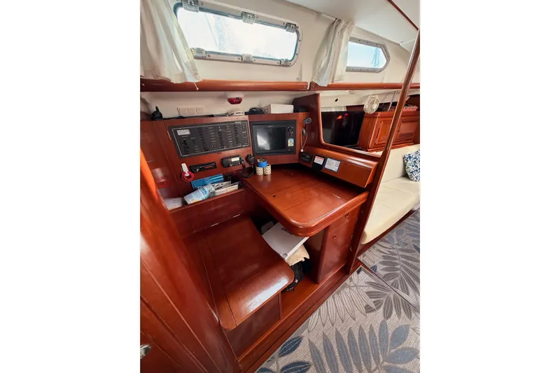 Parlay Yacht Photos Pics Interior of 2003 Beneteau Oceanis Clipper 473 yacht with navigation station and wooden finish.