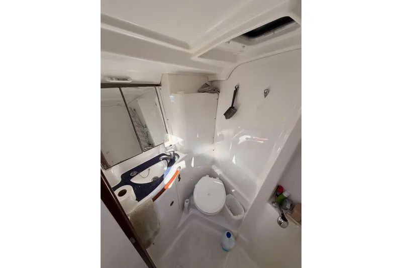 Parlay Yacht Photos Pics Bathroom interior of 2003 Beneteau Oceanis Clipper 473 yacht, featuring sink and toilet.