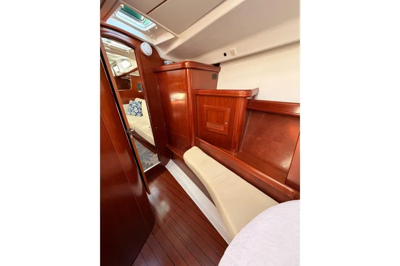 Parlay Yacht Photos Pics Luxurious interior of 2003 Beneteau Oceanis Clipper 473 sailboat with polished wood finish.
