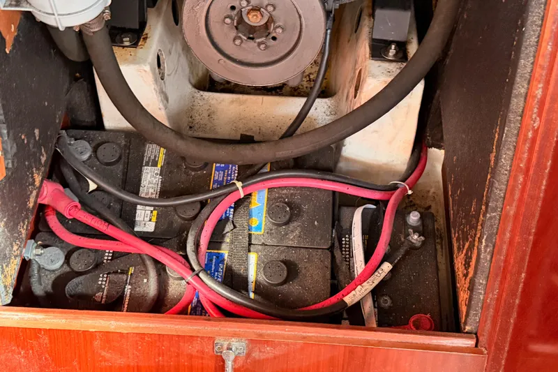 Parlay Yacht Photos Pics Battery compartment of a 2003 Beneteau Oceanis Clipper 473 sailboat with visible wiring.