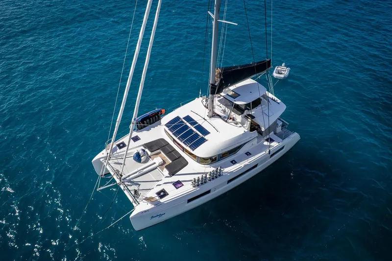 Scuba Doo Yacht Photos Pics 2021 Lagoon 50 catamaran sailing on clear blue ocean waters.