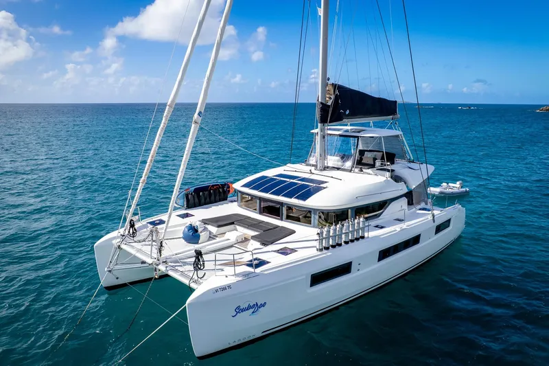 Scuba Doo Yacht Photos Pics 2021 Lagoon 50 catamaran sailing on clear blue ocean under sunny skies.