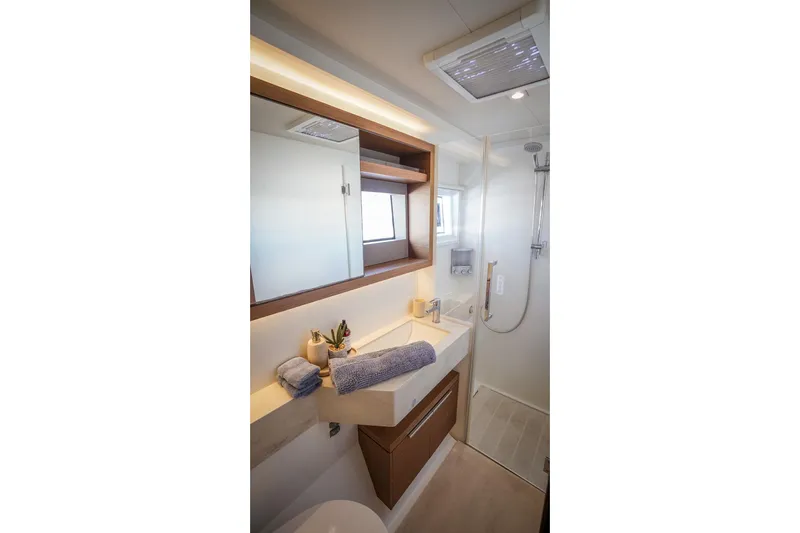 Scuba Doo Yacht Photos Pics Modern bathroom in 2021 Lagoon 50 yacht with sleek design and shower area.