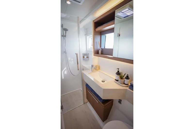 Scuba Doo Yacht Photos Pics Modern bathroom in 2021 Lagoon 50 yacht with sleek fixtures and elegant design.