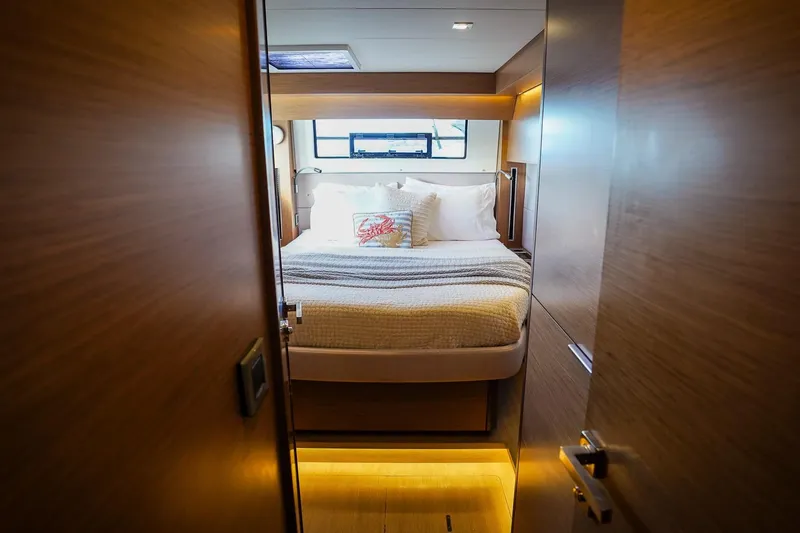Scuba Doo Yacht Photos Pics Luxurious cabin interior of 2021 Lagoon 50 yacht with cozy bed and modern design.