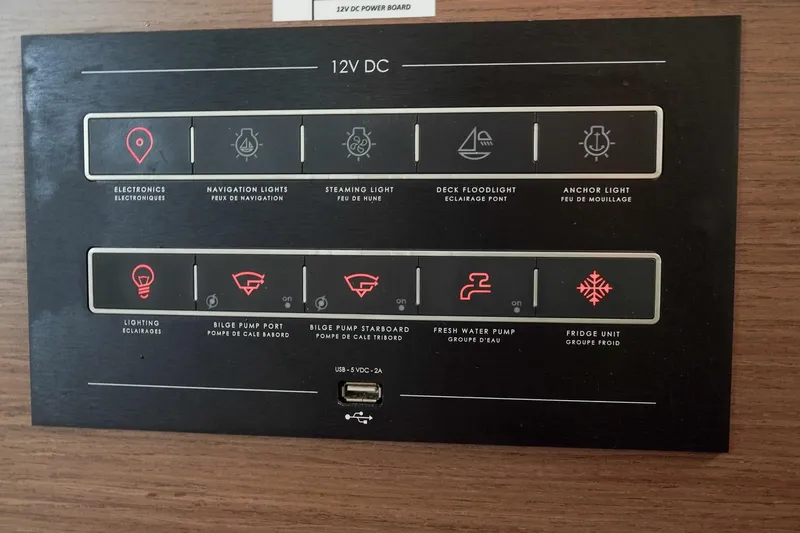 Scuba Doo Yacht Photos Pics Control panel of a 2021 Lagoon 50 yacht, featuring various 12V DC system switches.