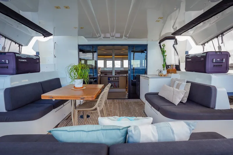 Scuba Doo Yacht Photos Pics Luxurious interior of 2021 Lagoon 50 catamaran with modern seating and dining area.