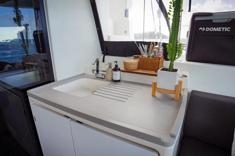 Scuba Doo Yacht Photos Pics Modern kitchen area on a 2021 Lagoon 50 yacht with sink and decor.