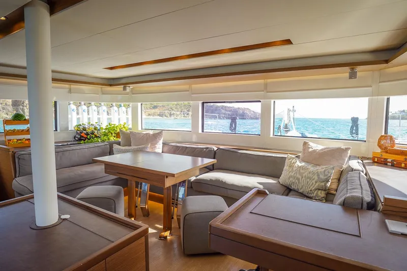 Scuba Doo Yacht Photos Pics Luxurious interior of 2021 Lagoon 50 yacht with ocean view and comfortable seating.