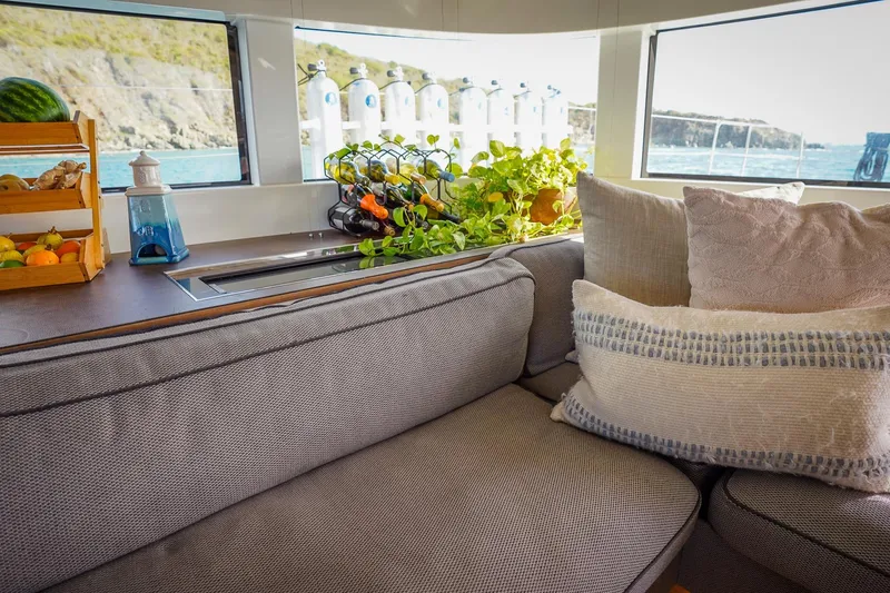 Scuba Doo Yacht Photos Pics Interior of 2021 Lagoon 50 yacht with cozy seating and scenic ocean view.