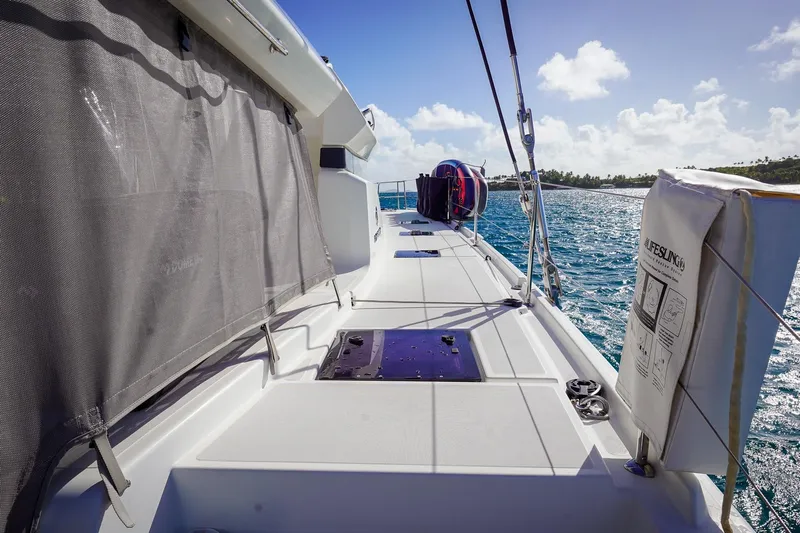 Scuba Doo Yacht Photos Pics 2021 Lagoon 50 catamaran deck with safety equipment, sailing on blue ocean waters.