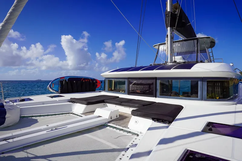 Scuba Doo Yacht Photos Pics 2021 Lagoon 50 catamaran with spacious deck, sailing on clear blue ocean.