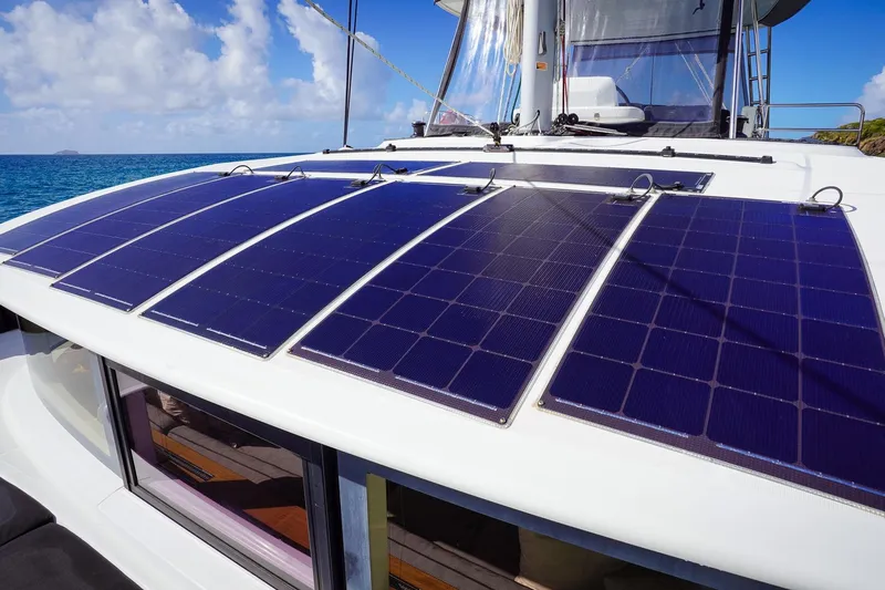 Scuba Doo Yacht Photos Pics Solar panels on 2021 Lagoon 50 catamaran, ocean background, sustainable energy.