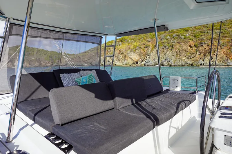 Scuba Doo Yacht Photos Pics Luxurious seating area on a 2021 Lagoon 50 catamaran, overlooking serene coastal waters.