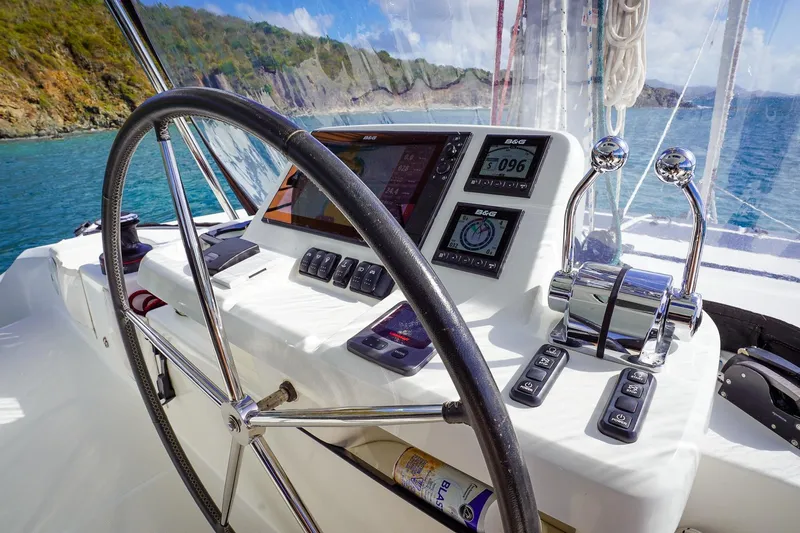 Scuba Doo Yacht Photos Pics Steering wheel and controls of a 2021 Lagoon 50 yacht, with scenic ocean view.